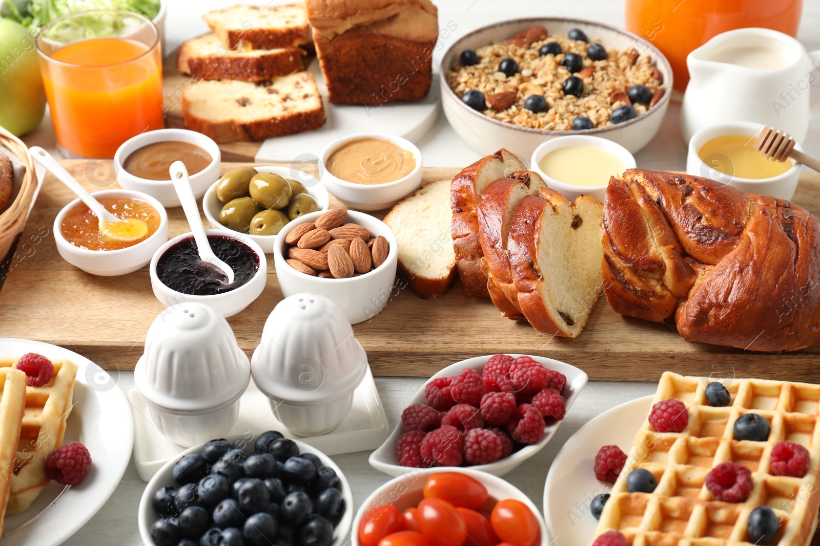 Photo of Different meals served for breakfast on white table