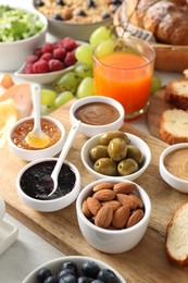 Different meals served for breakfast on white table