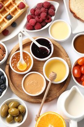 Photo of Different meals served for breakfast on white table, flat lay