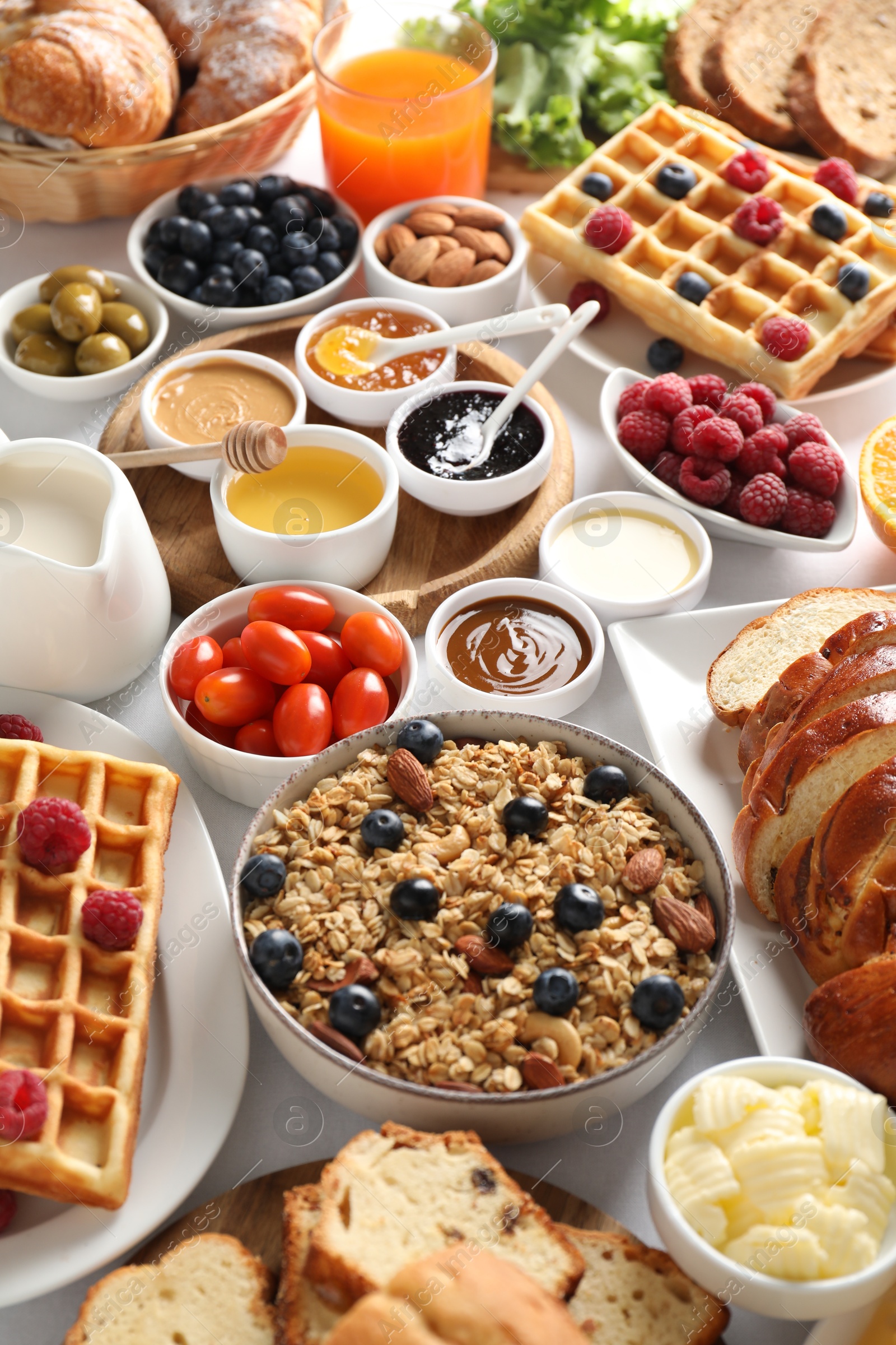 Photo of Different meals served for breakfast on white table