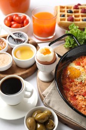 Photo of Cup of coffee and different meals served for breakfast on white table, closeup