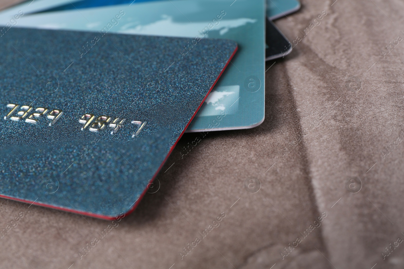 Photo of Credit cards on grey textured table, closeup. Space for text