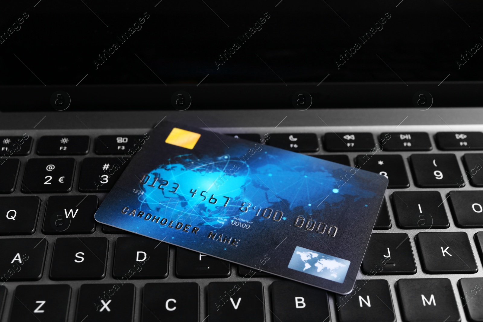 Photo of One plastic credit card on modern laptop