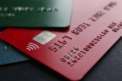 Different credit cards on black background, closeup