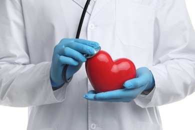 Photo of Doctor with stethoscope and red heart isolated on white, closeup