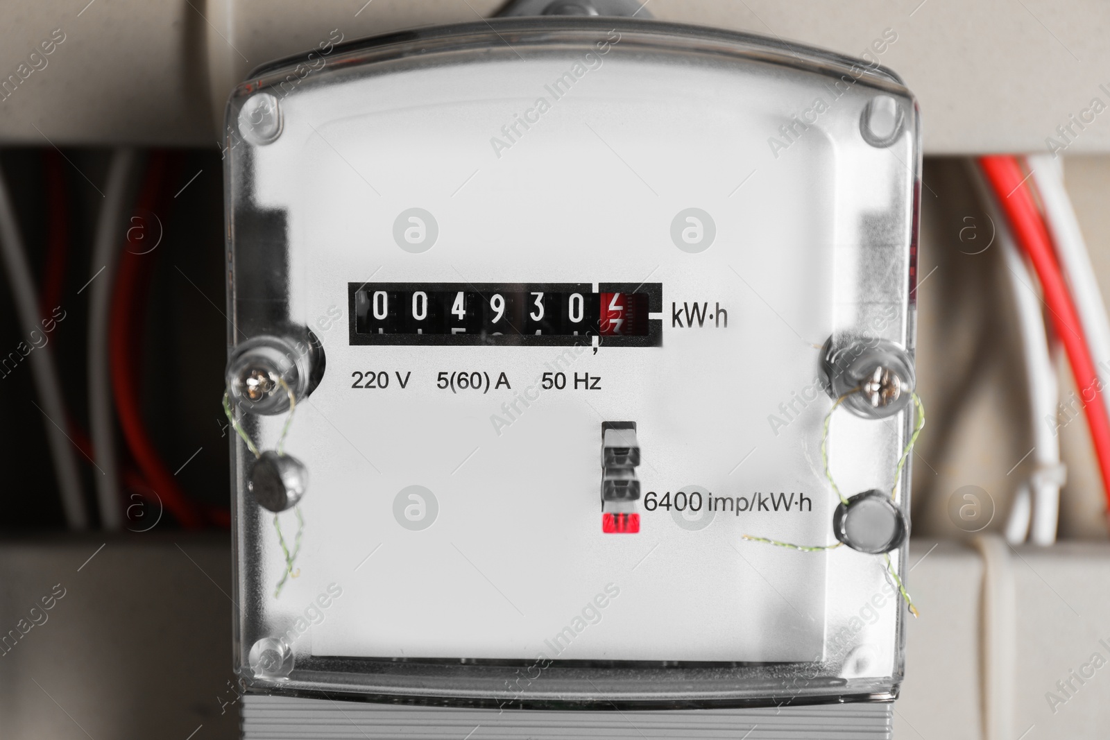 Photo of Electric meter and wires in fuse box, closeup. Energy measuring device