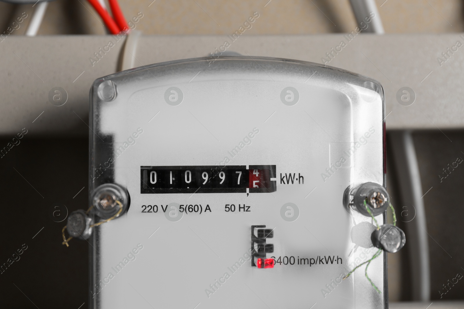 Photo of Electric meter and wires in fuse box, closeup. Energy measuring device