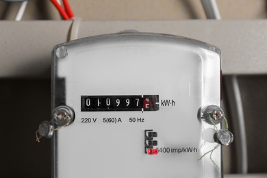 Photo of Electric meter and wires in fuse box, closeup. Energy measuring device