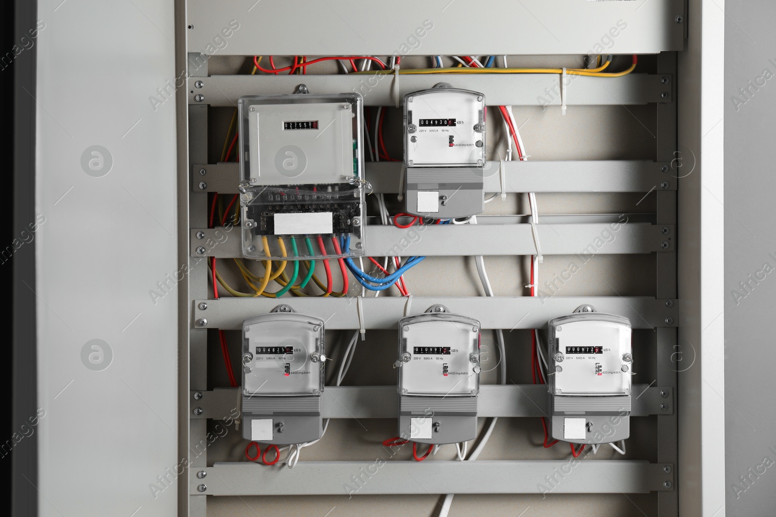 Photo of Electric meters and wires in fuse box. Energy measuring device