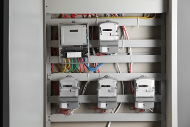 Photo of Electric meters and wires in fuse box. Energy measuring device