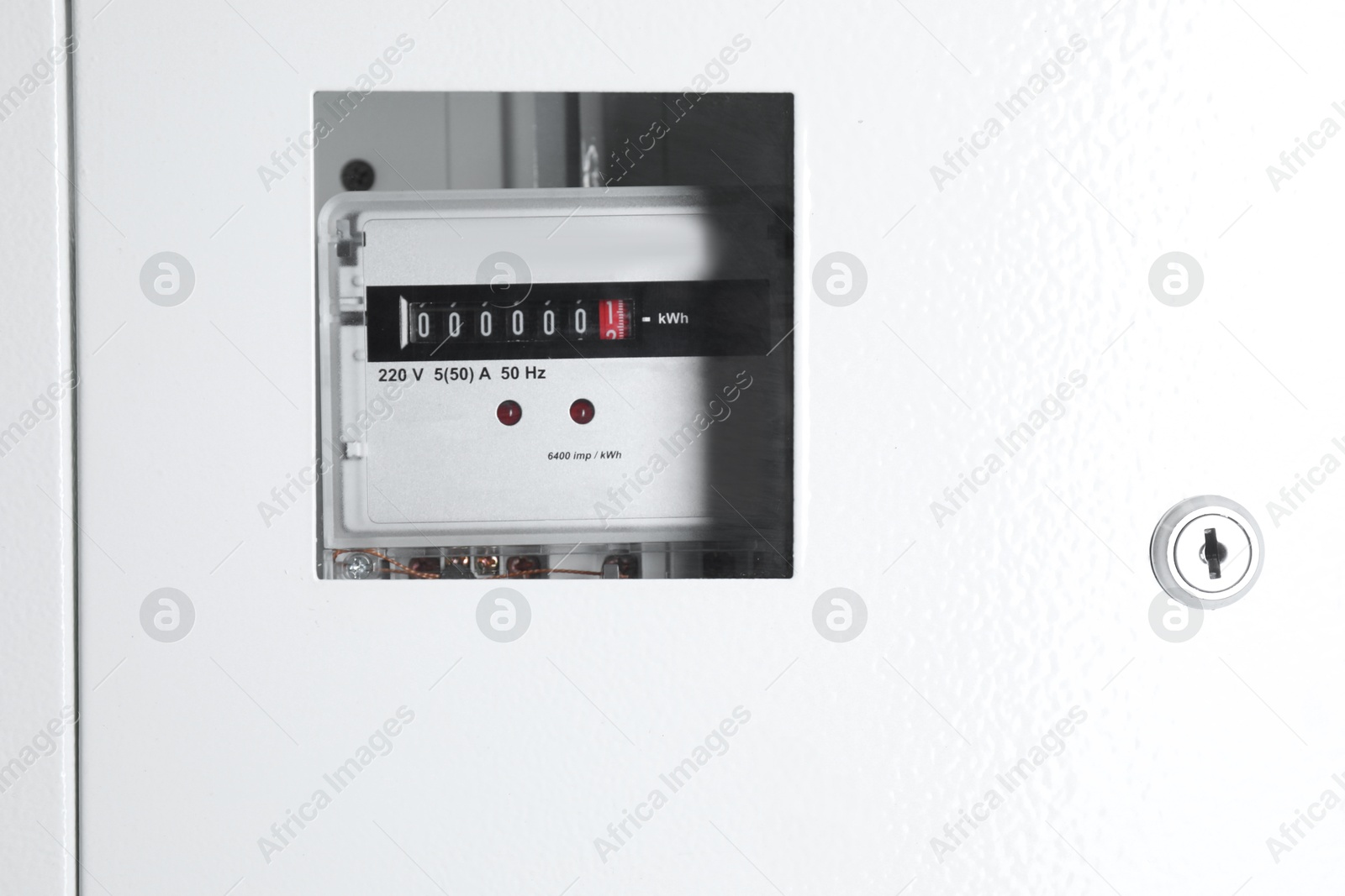 Photo of Electric meter in metal fuse box. Energy measuring device