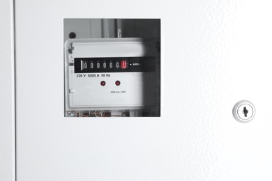 Photo of Electric meter in metal fuse box. Energy measuring device