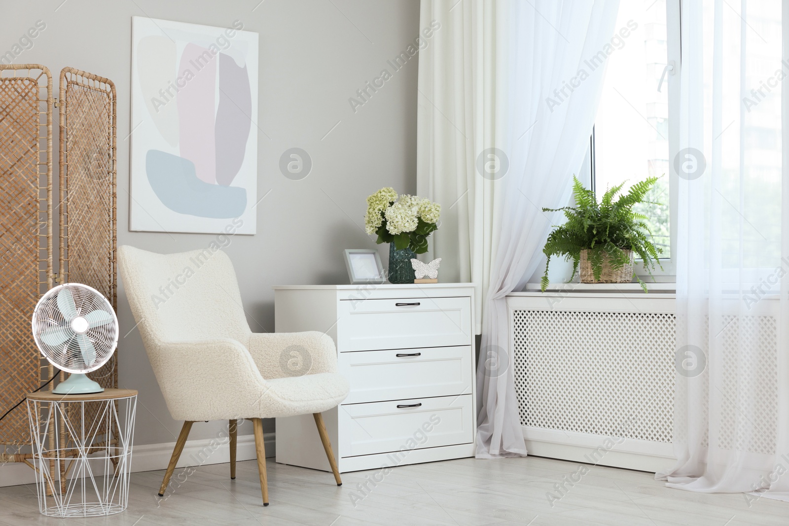 Photo of Soft armchair, chest of drawers, houseplant and window with curtains in room. Interior design