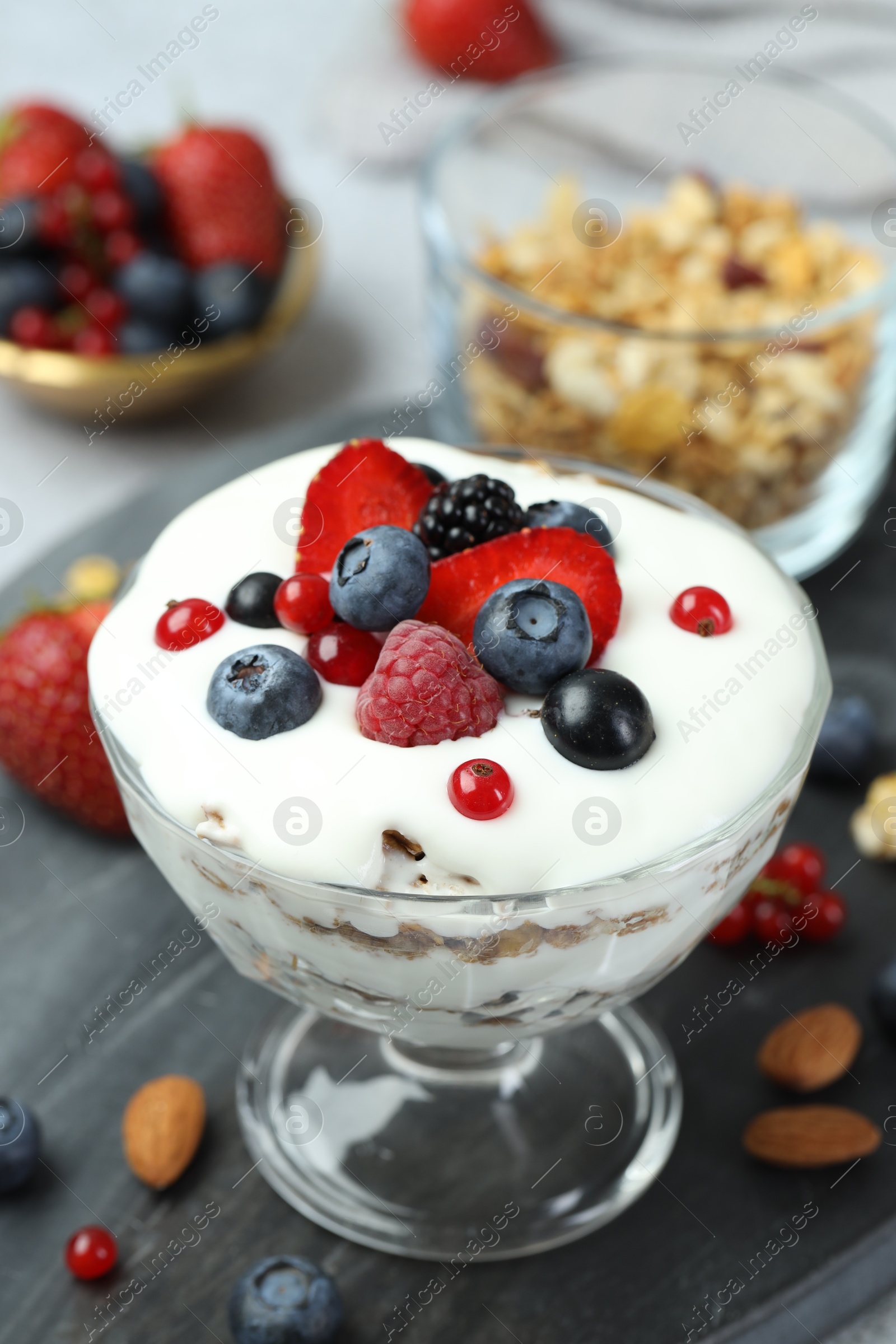 Photo of Tasty yogurt with fresh berries on table, closeup