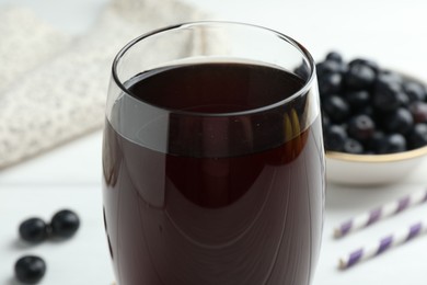 Photo of Tasty fresh acai juice in glass on white table, closeup