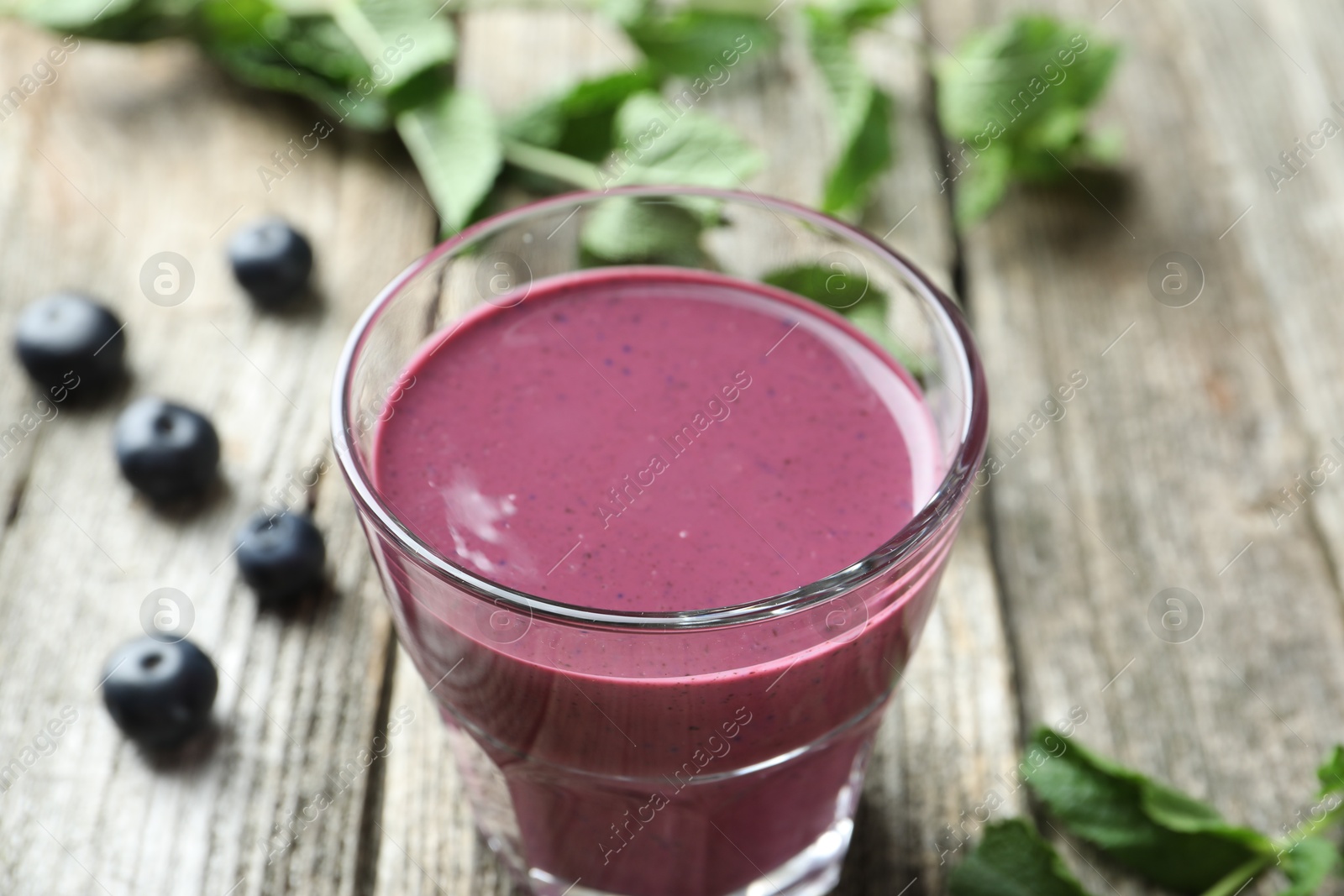 Photo of Tasty fresh acai juice in glass on table, closeup