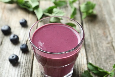 Photo of Tasty fresh acai juice in glass on table, closeup