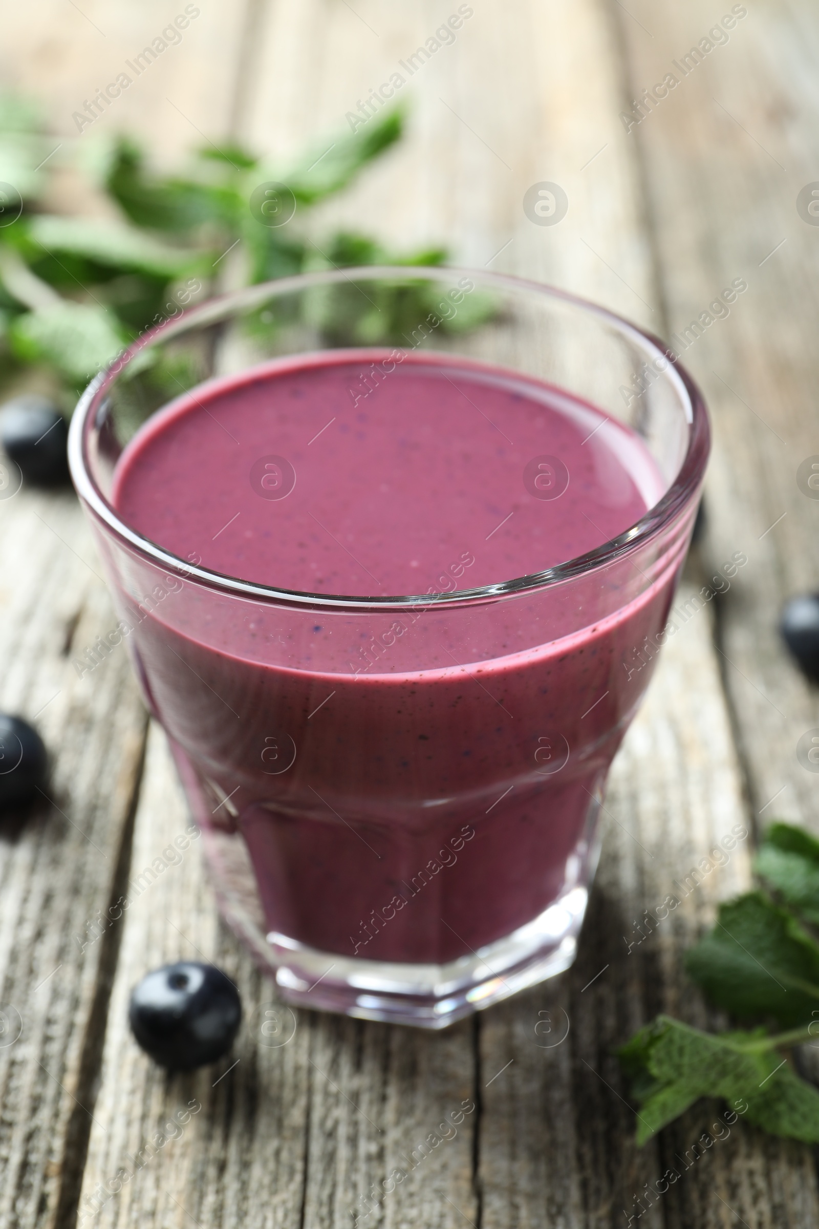 Photo of Tasty fresh acai juice in glass on table, closeup