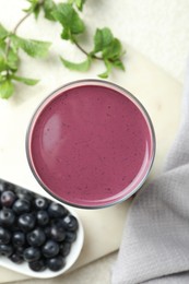 Photo of Tasty fresh acai juice in glass on light table, top view