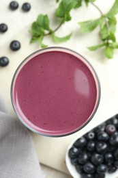 Photo of Tasty fresh acai juice in glass on light table, top view