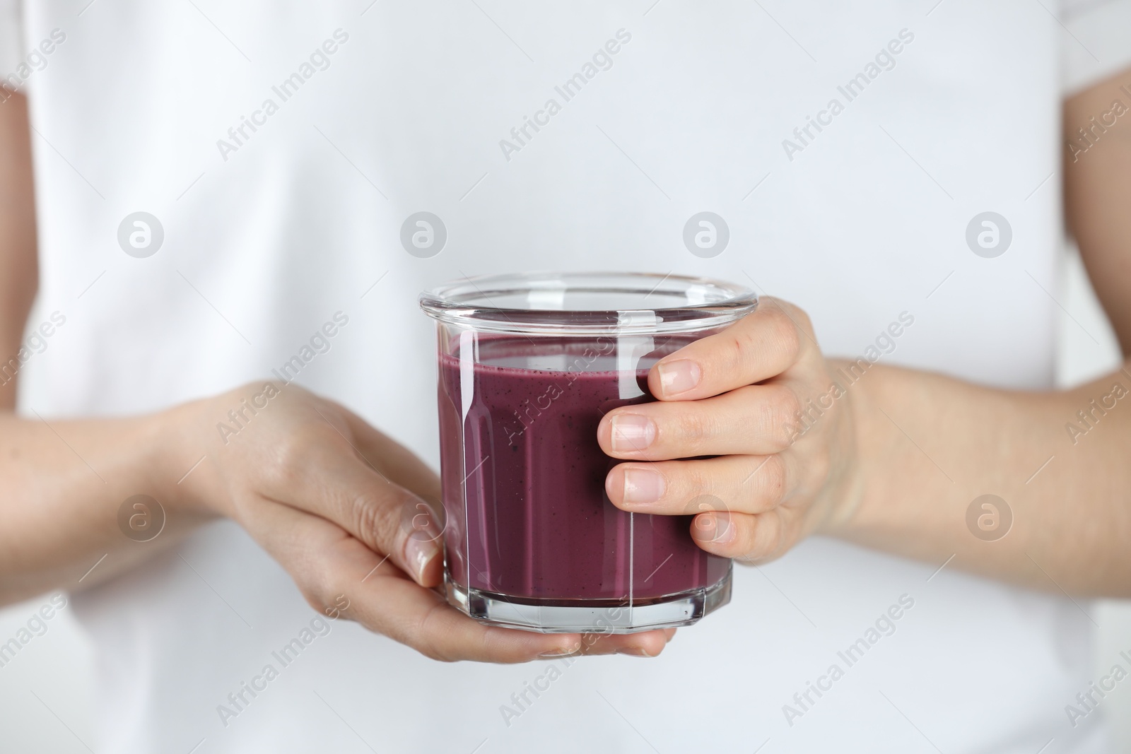 Photo of Woman with glass of tasty fresh acai juice, closeup