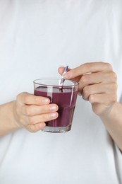 Photo of Woman with glass of tasty fresh acai juice, closeup