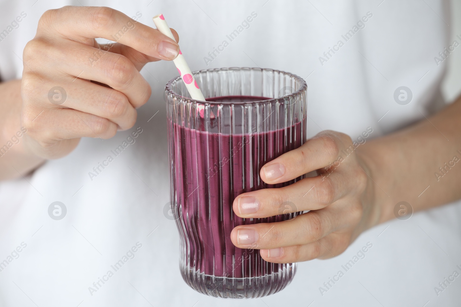 Photo of Woman with glass of tasty fresh acai juice, closeup