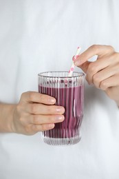 Photo of Woman with glass of tasty fresh acai juice, closeup