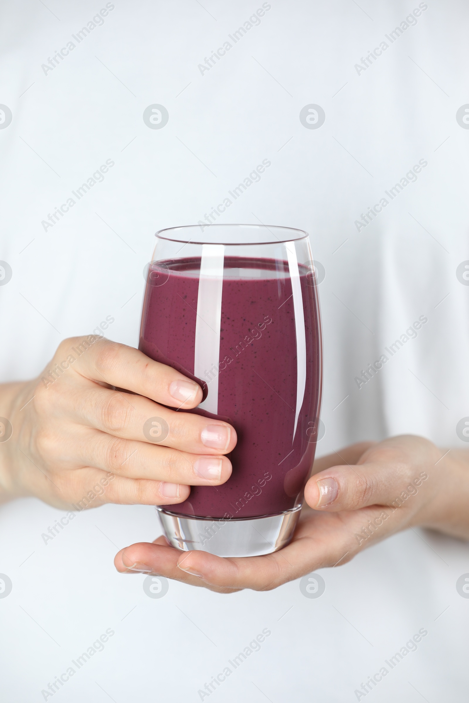 Photo of Woman with glass of tasty fresh acai juice, closeup