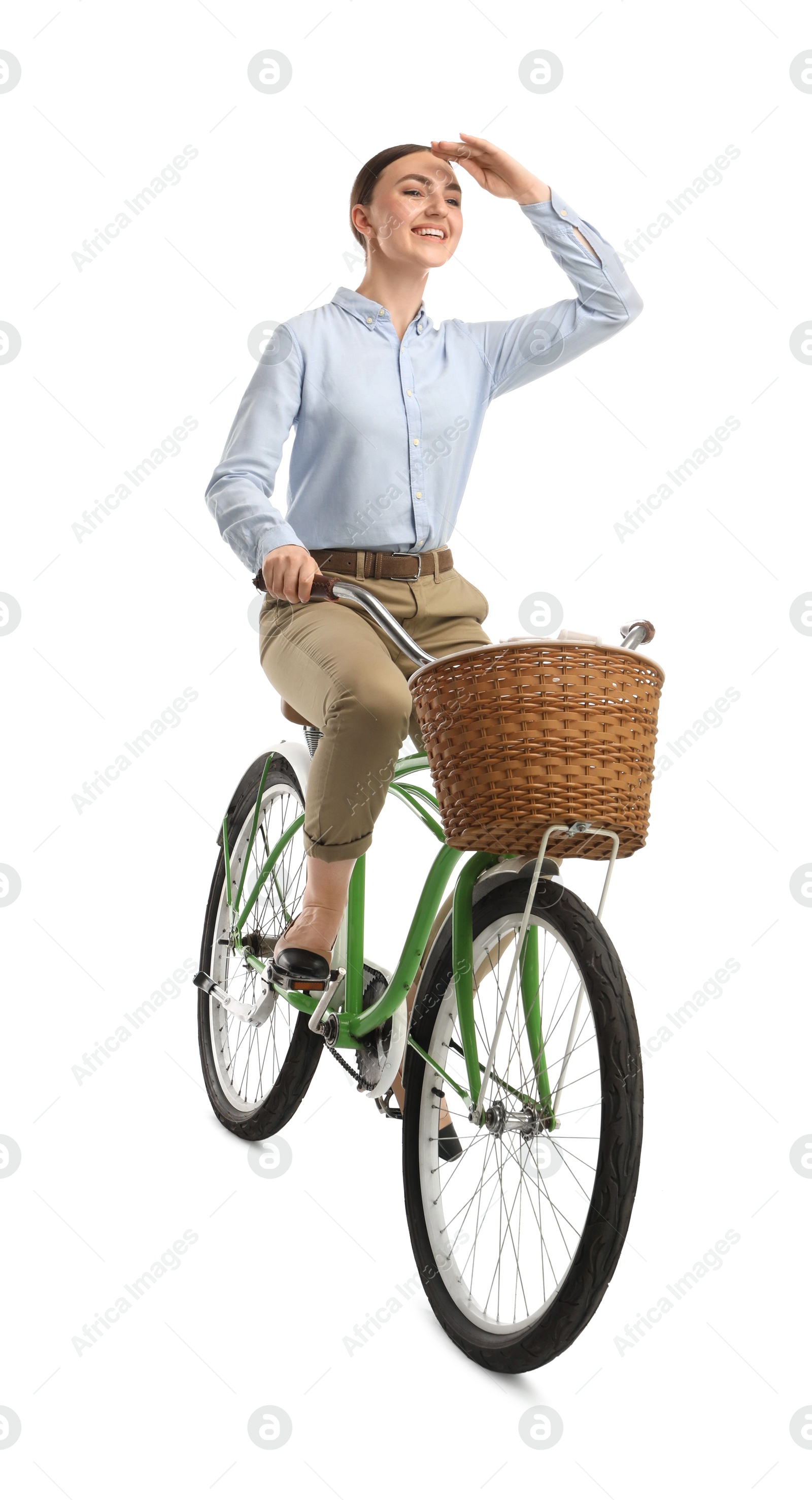 Photo of Smiling woman riding bicycle with basket on white background