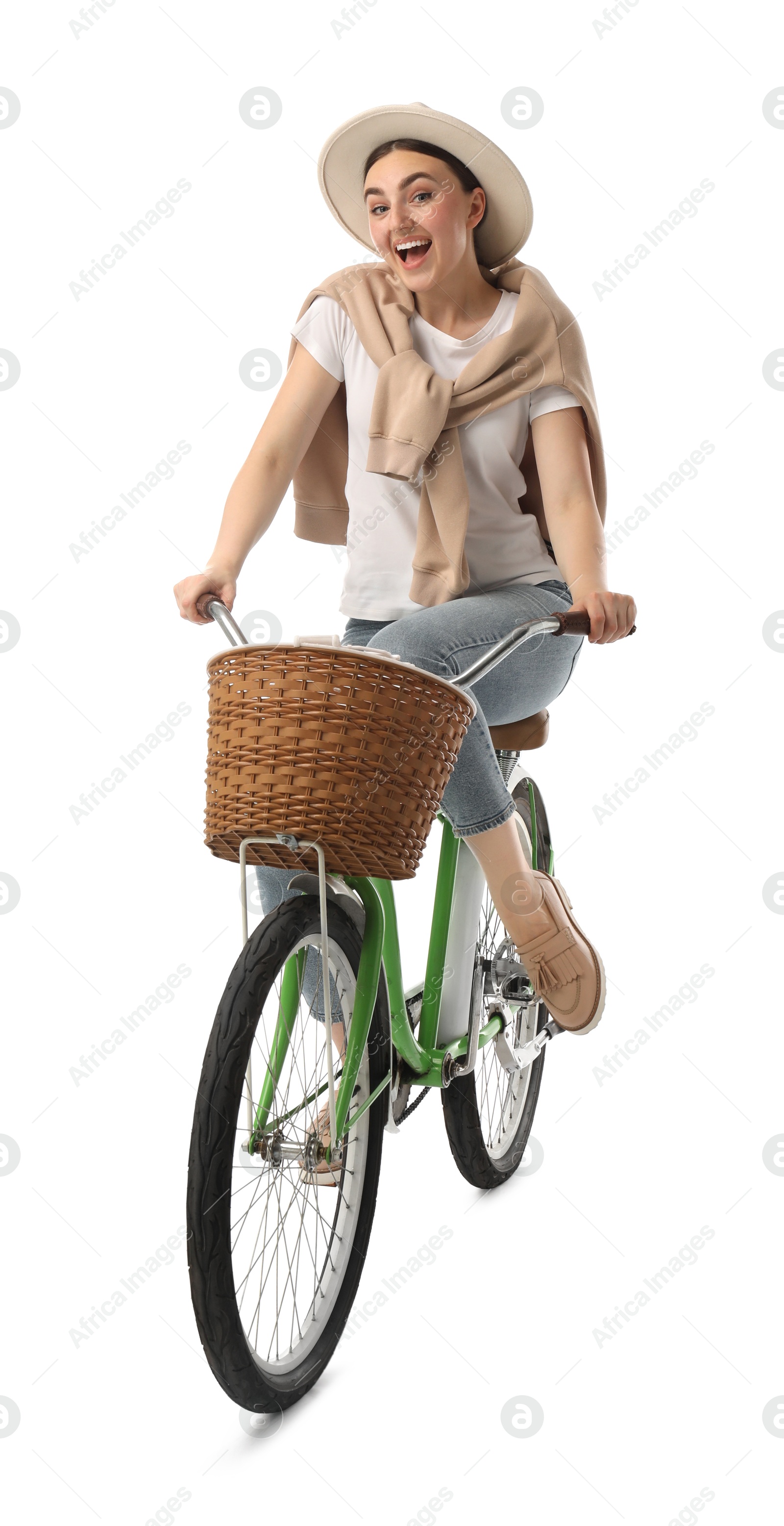 Photo of Smiling woman riding bicycle with basket against white background