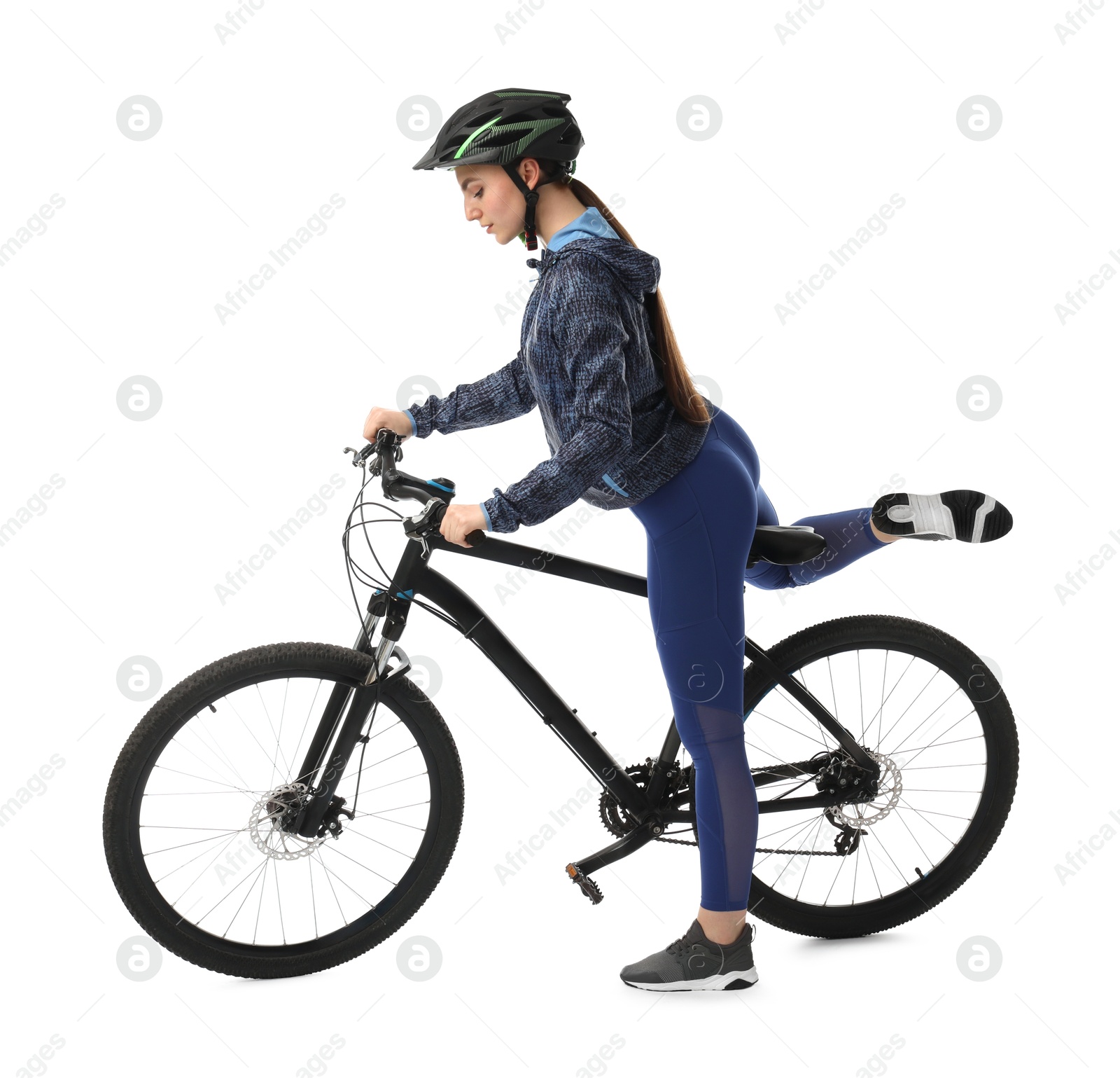 Photo of Beautiful young woman in helmet near bicycle on white background