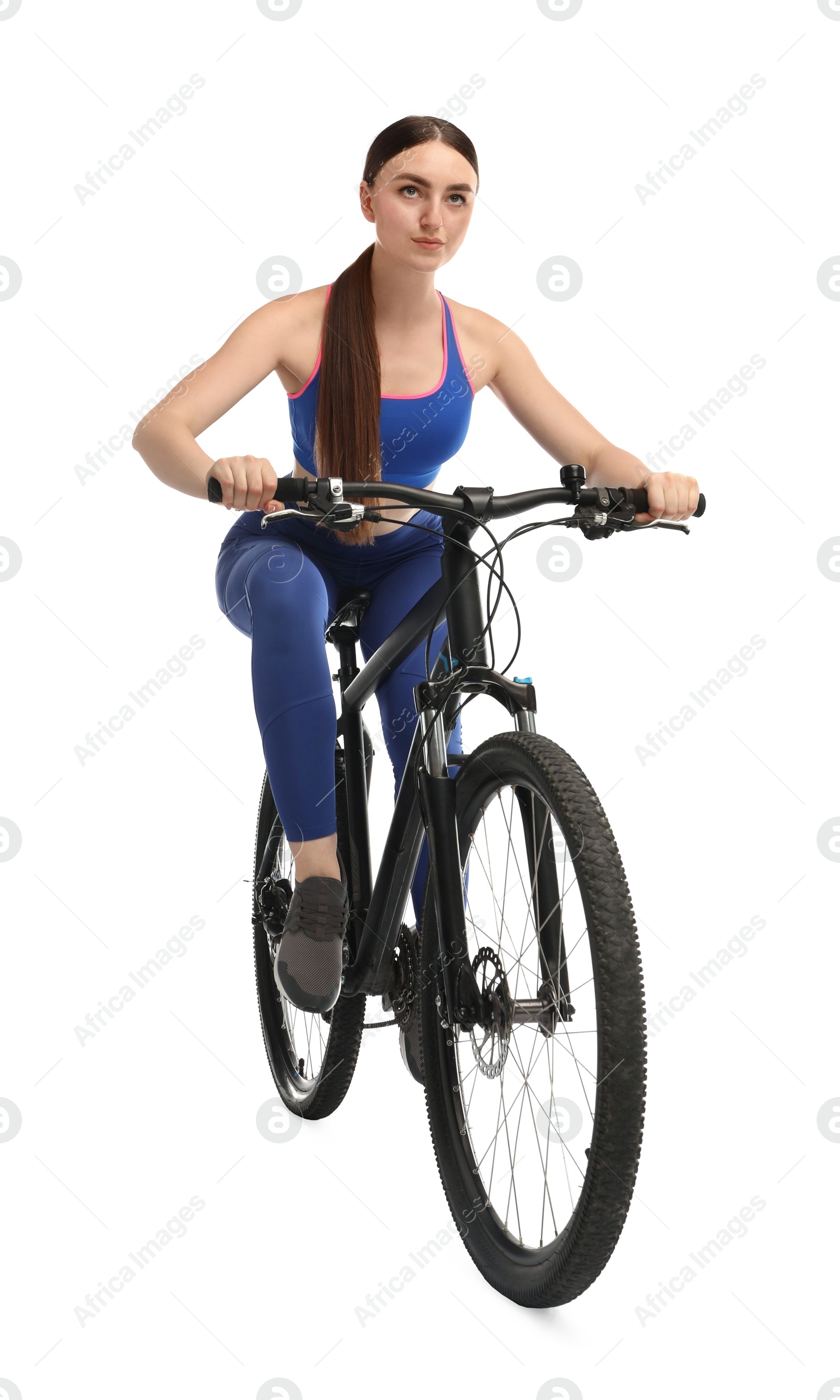 Photo of Beautiful young woman riding bicycle on white background