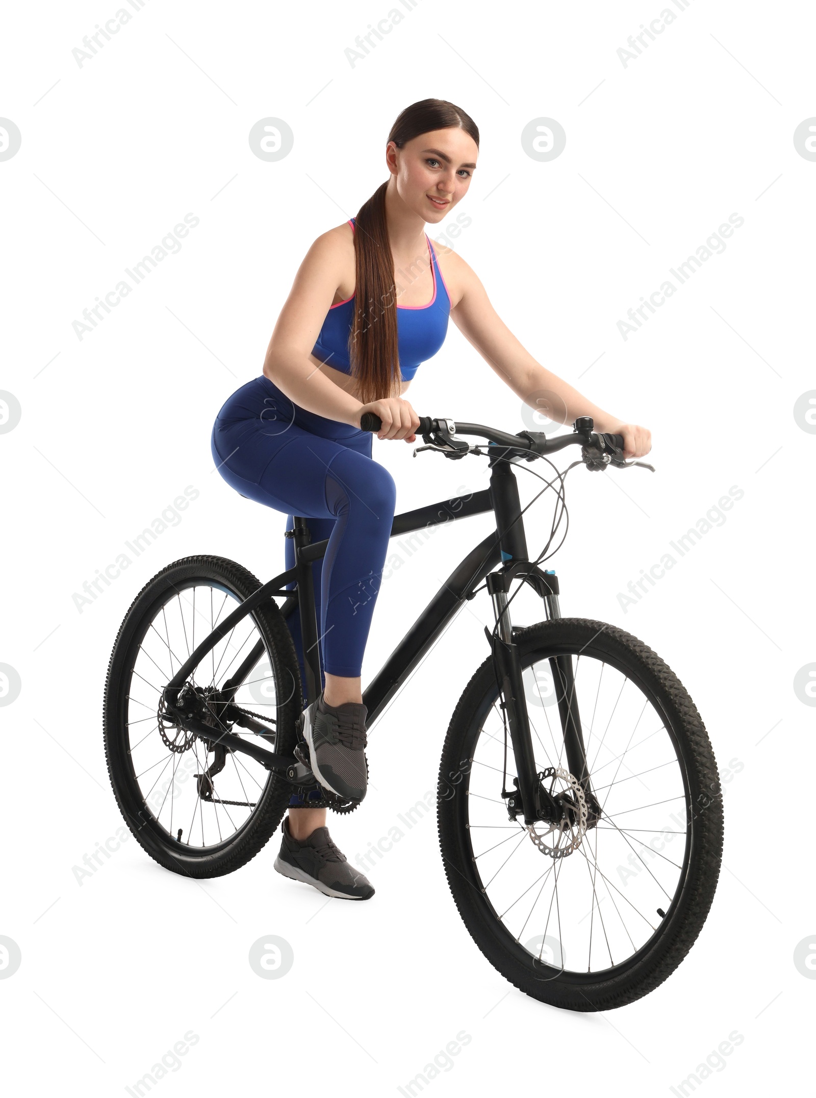 Photo of Smiling woman riding bicycle on white background