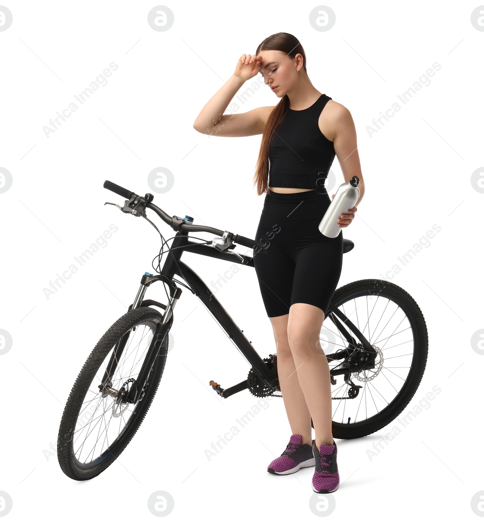 Photo of Beautiful young woman with bicycle and bottle of drink isolated on white