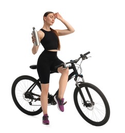 Photo of Beautiful young woman with bicycle and bottle of drink isolated on white