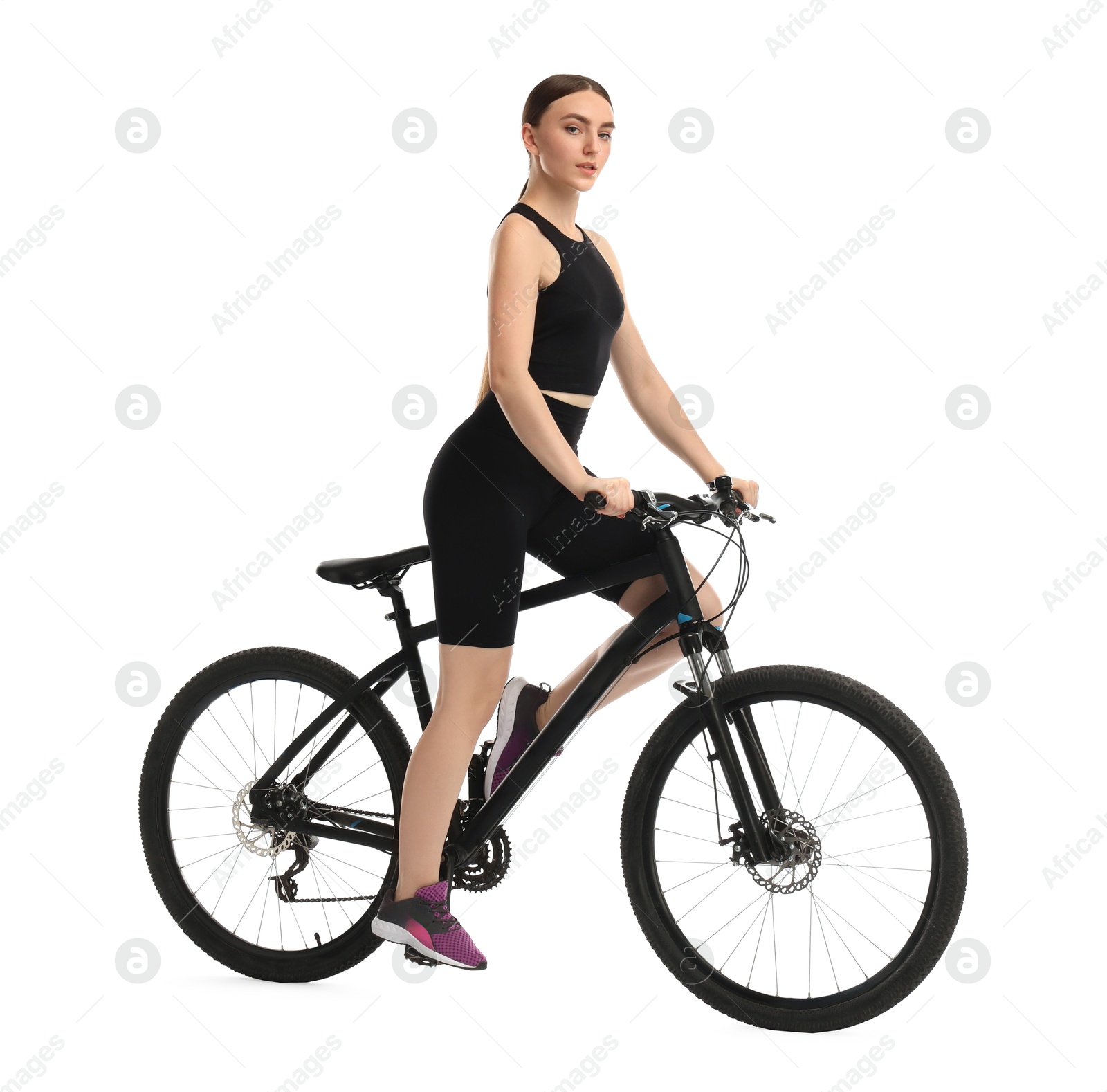 Photo of Beautiful young woman riding bicycle on white background