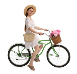 Photo of Smiling woman riding bicycle with basket of peony flowers on white background