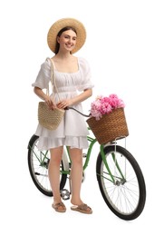 Photo of Smiling woman with bicycle and basket of peony flowers isolated on white