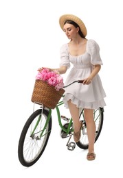 Photo of Beautiful young woman with bicycle and basket of peony flowers isolated on white