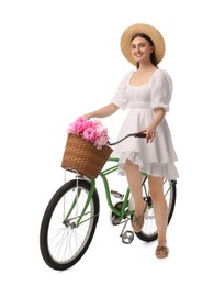 Photo of Smiling woman on bicycle with basket of peony flowers against white background