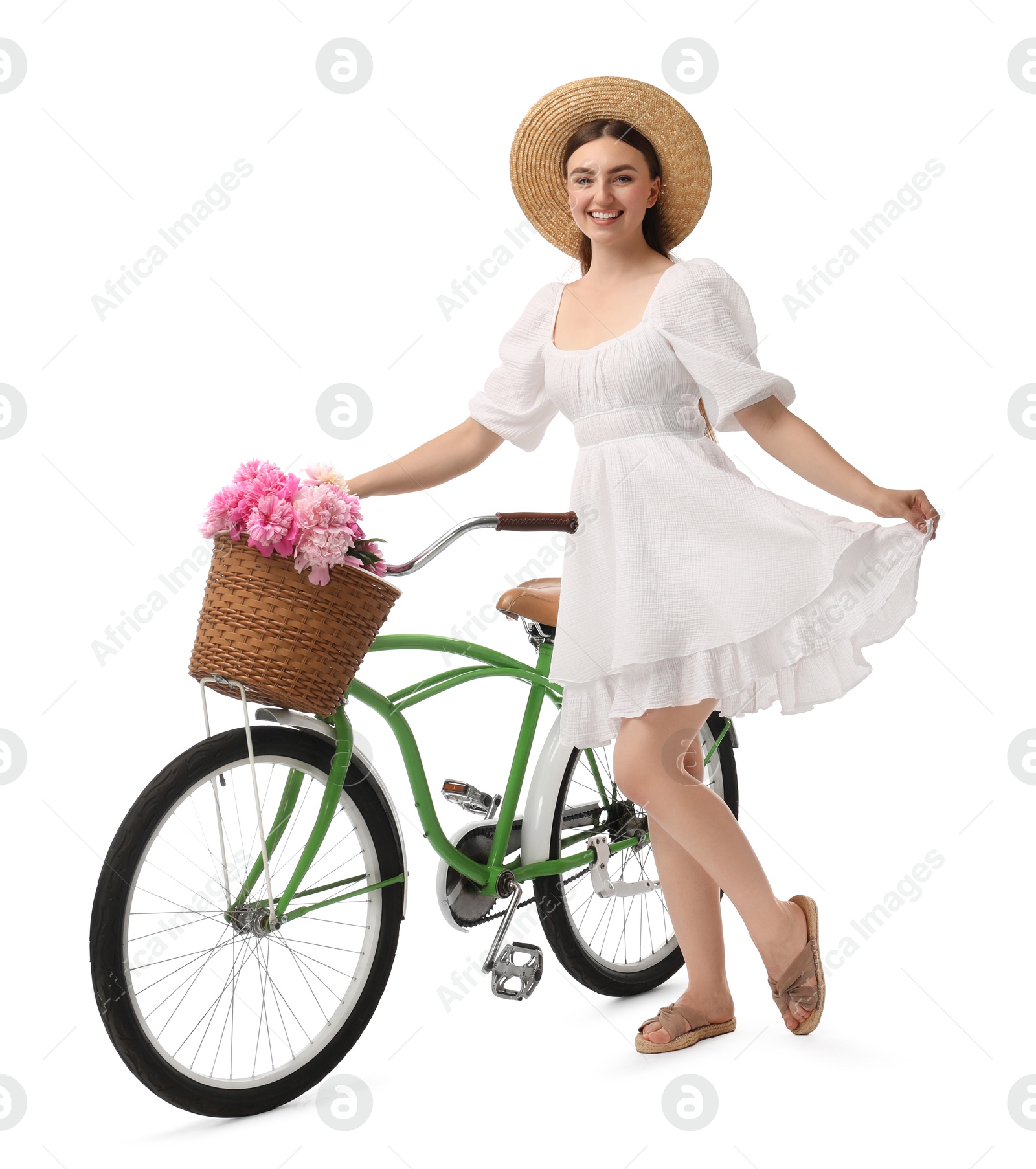 Photo of Smiling woman with bicycle and basket of peony flowers isolated on white