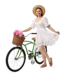Photo of Smiling woman with bicycle and basket of peony flowers isolated on white