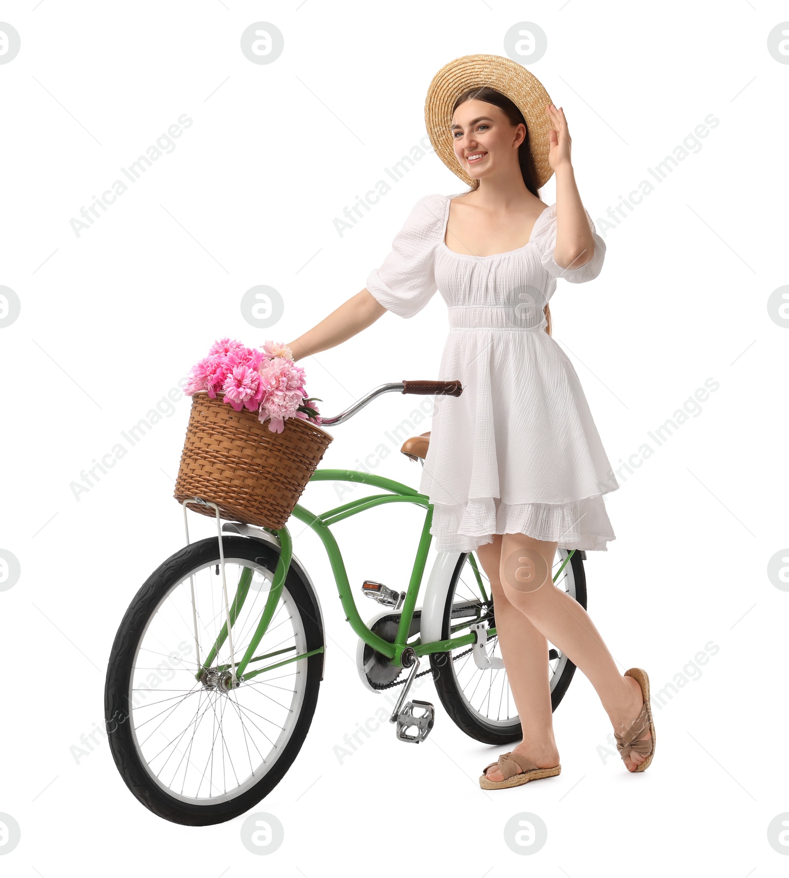 Photo of Smiling woman with bicycle and basket of peony flowers isolated on white