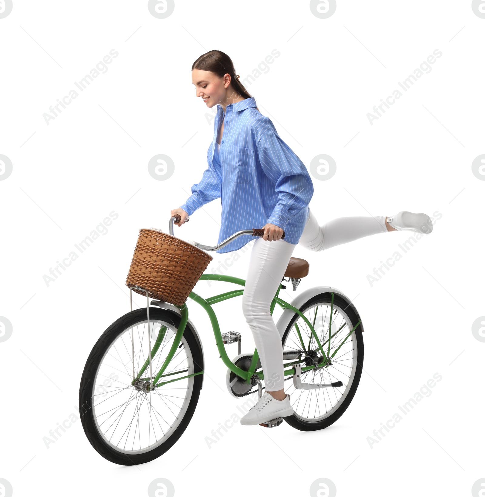 Photo of Smiling woman riding bicycle with basket on white background