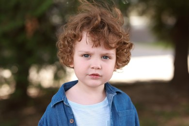 Photo of Portrait of little boy outdoors. Cute child