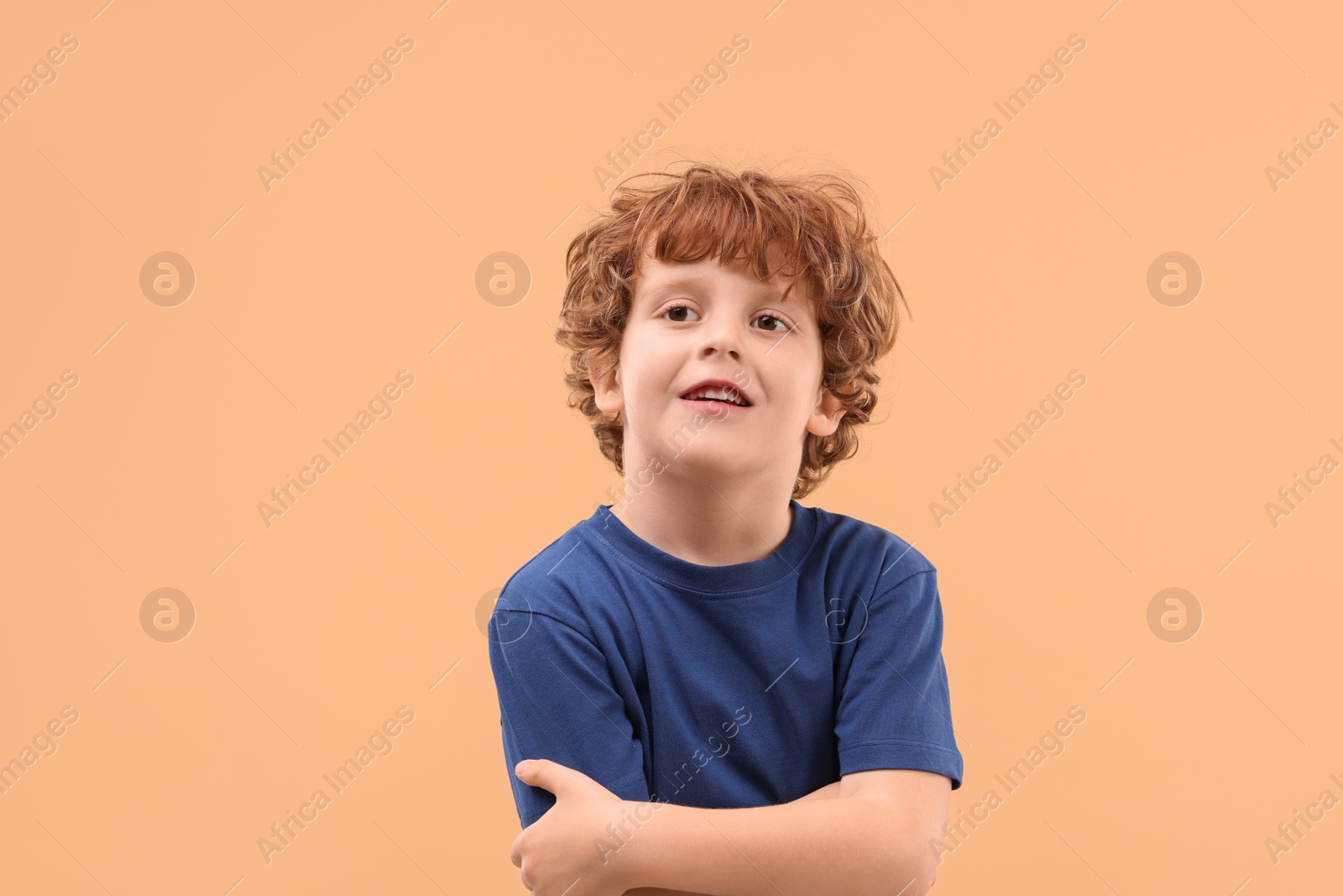 Photo of Portrait of cute little boy on beige background