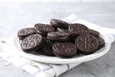 Many tasty sandwich cookies on light grey table