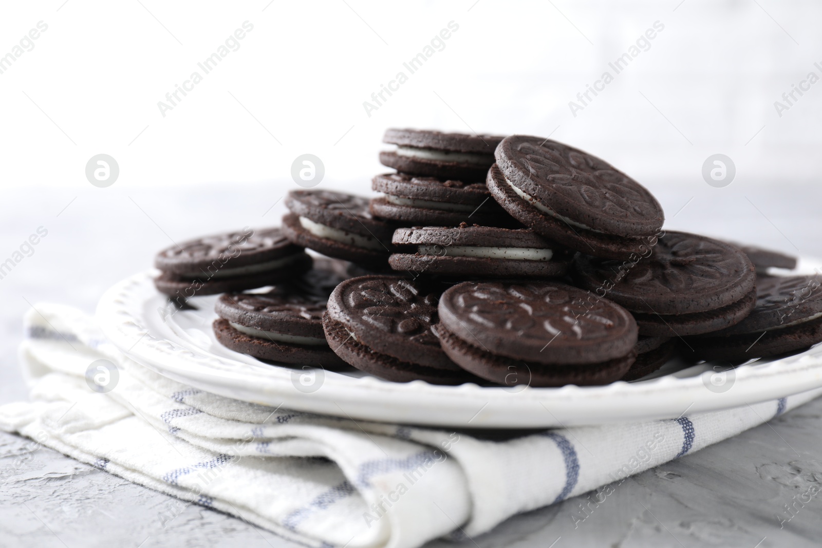 Photo of Many tasty sandwich cookies on light grey table