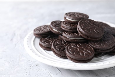 Photo of Many tasty sandwich cookies on light grey table